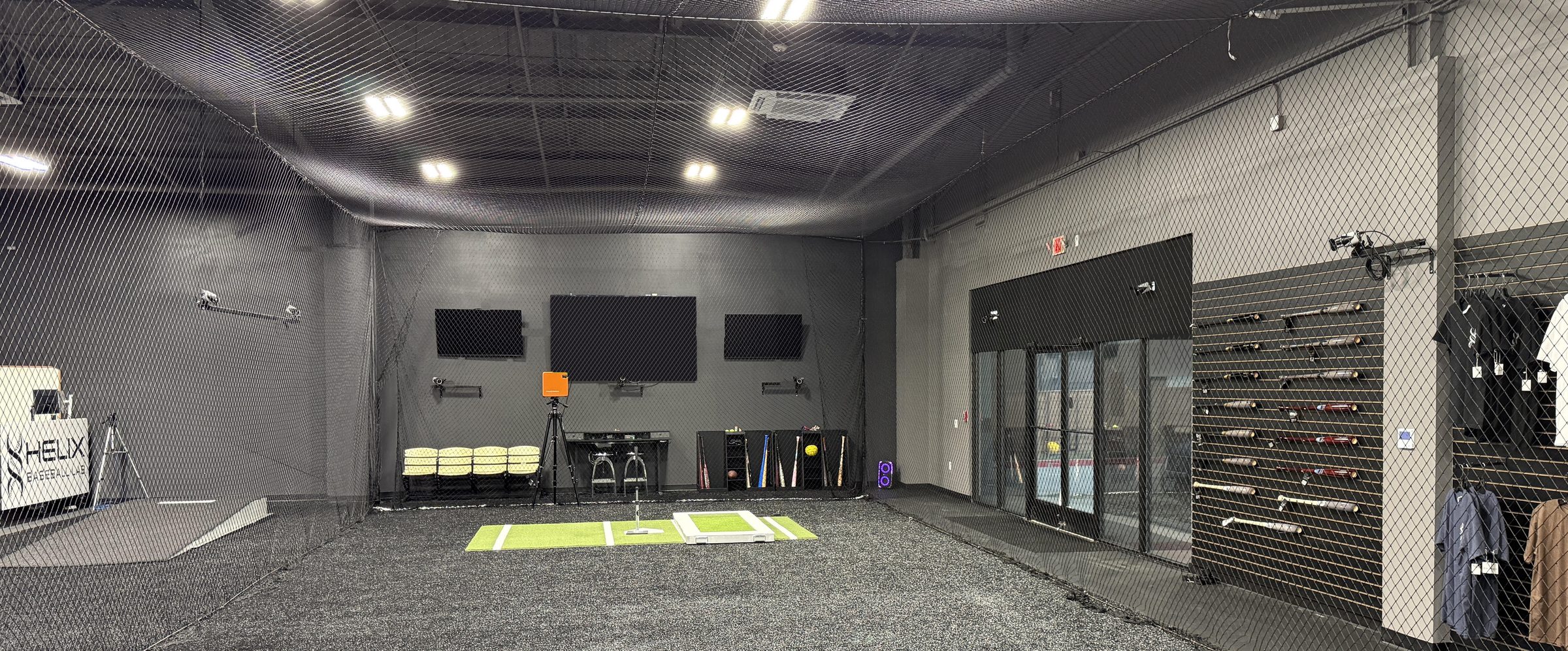 The Helix Baseball Lab hitting cage in Farmers Branch, Texas, with the bat wall, turf mats and capture cameras
